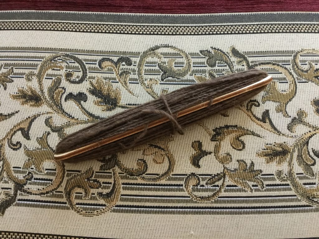 Small shuttle of brown Navajo Churro yarn hand spun by a Navajo woman