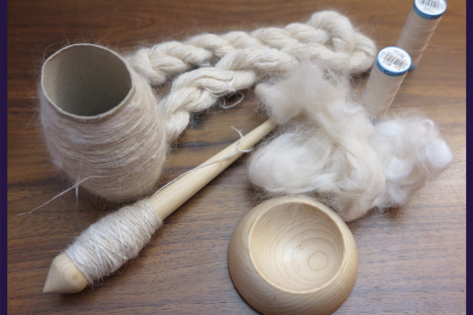Clockwise from lower left: a pale wood supported spindle with threadlike cream yarn, a toilet paper roll with more of the same yarn, a small skein of plied white yarn, clouds of fawn angora, the matching wood support bowl.